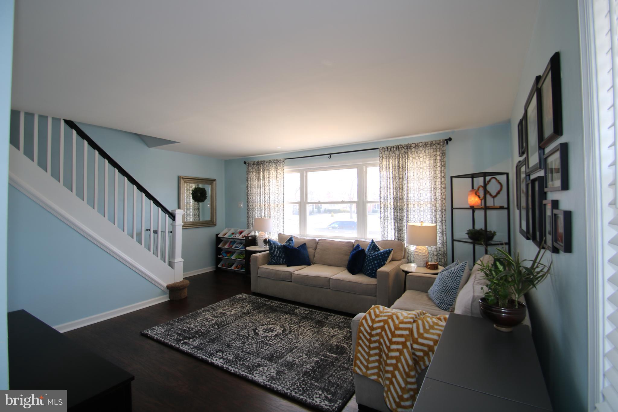 1421 Blackrock Road Swarthmore, PA 19081 - Photo 5 of 41 a living room with furniture and a book shelf