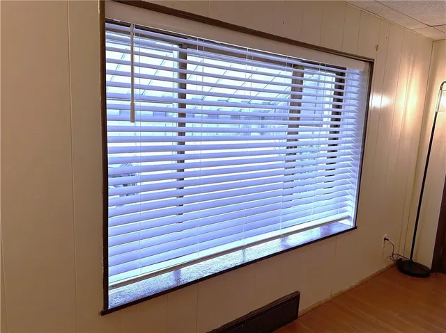 a view of an empty room with a chandelier fan