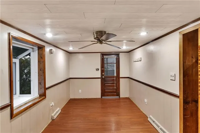 a view of an empty room with wooden floor