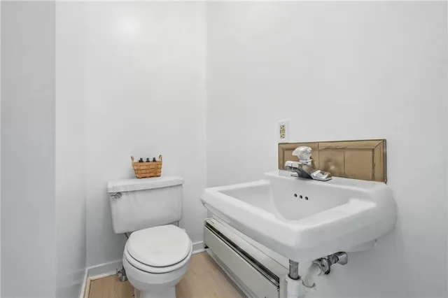 a white toilet sitting next to a bathroom sink