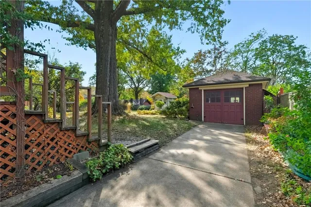 front view of a house with a tree in the background