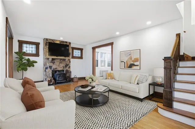 a living room with furniture a flat screen tv and a fireplace