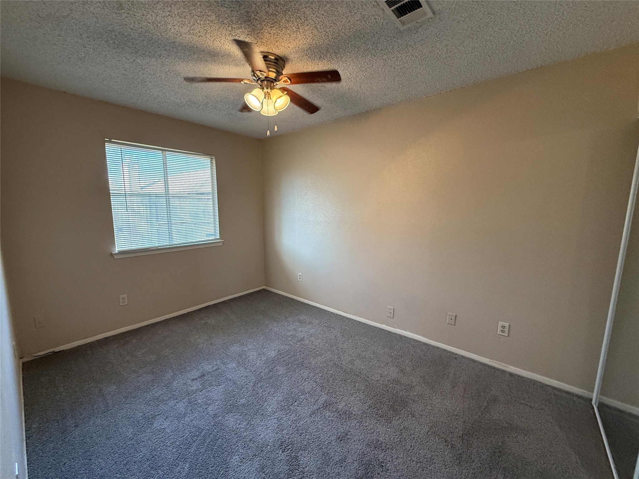 3219 Forestbrook Drive Spring, TX 77373 - Photo 12 of 16 Bedroom 3 with neutral walls, a ceiling fan, carpeted floor, and a window allowing natural light.