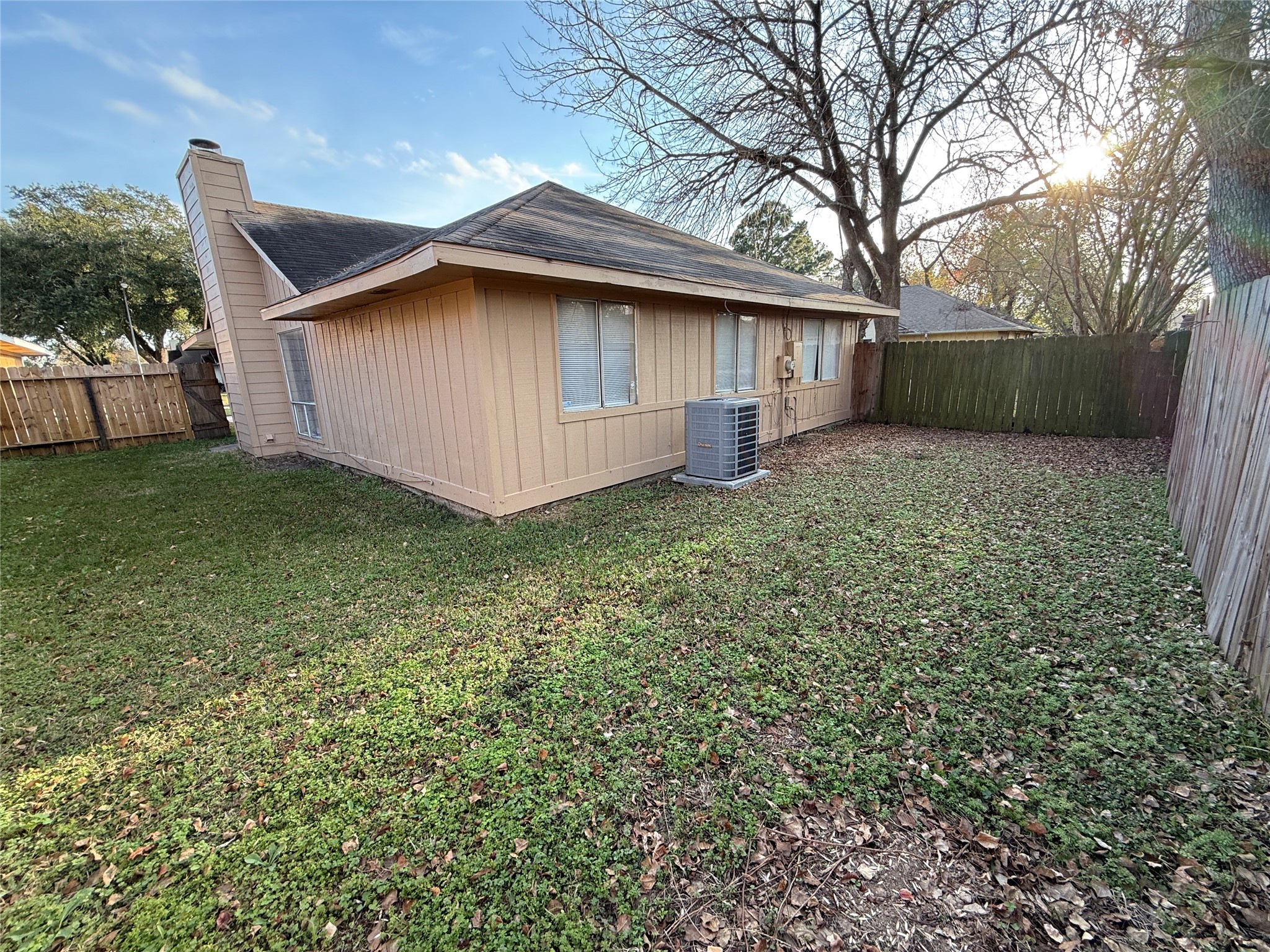3219 Forestbrook Drive Spring, TX 77373 - Photo 2 of 16 Backyard with a wooden fence, grassy area. Ideal for outdoor relaxation.
