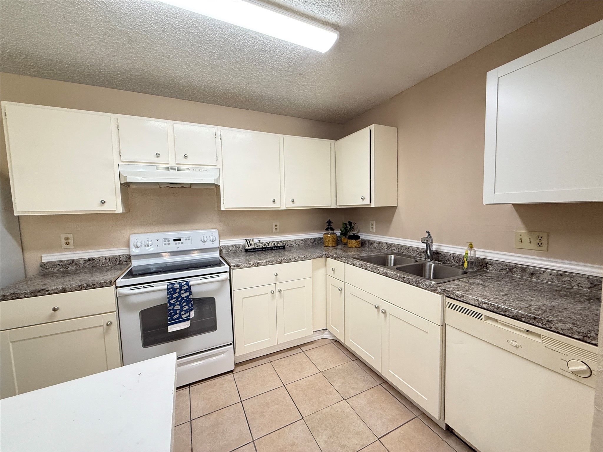 3219 Forestbrook Drive Spring, TX 77373 - Photo 4 of 16 Discover the charm of this modern kitchen, featuring sleek white appliances and ample counter space for culinary creativity.