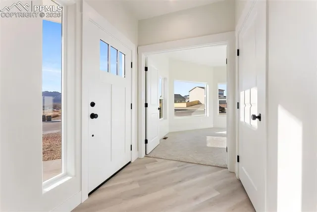 a view of a hallway with a cabinet and a living room