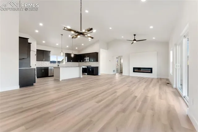 a view of a kitchen with a sink and a refrigerator