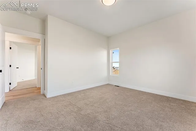 an empty room with windows and closet