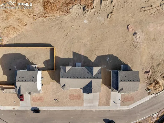 an aerial view of residential houses with outdoor space