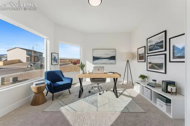 a living room with furniture a rug and a flat screen tv