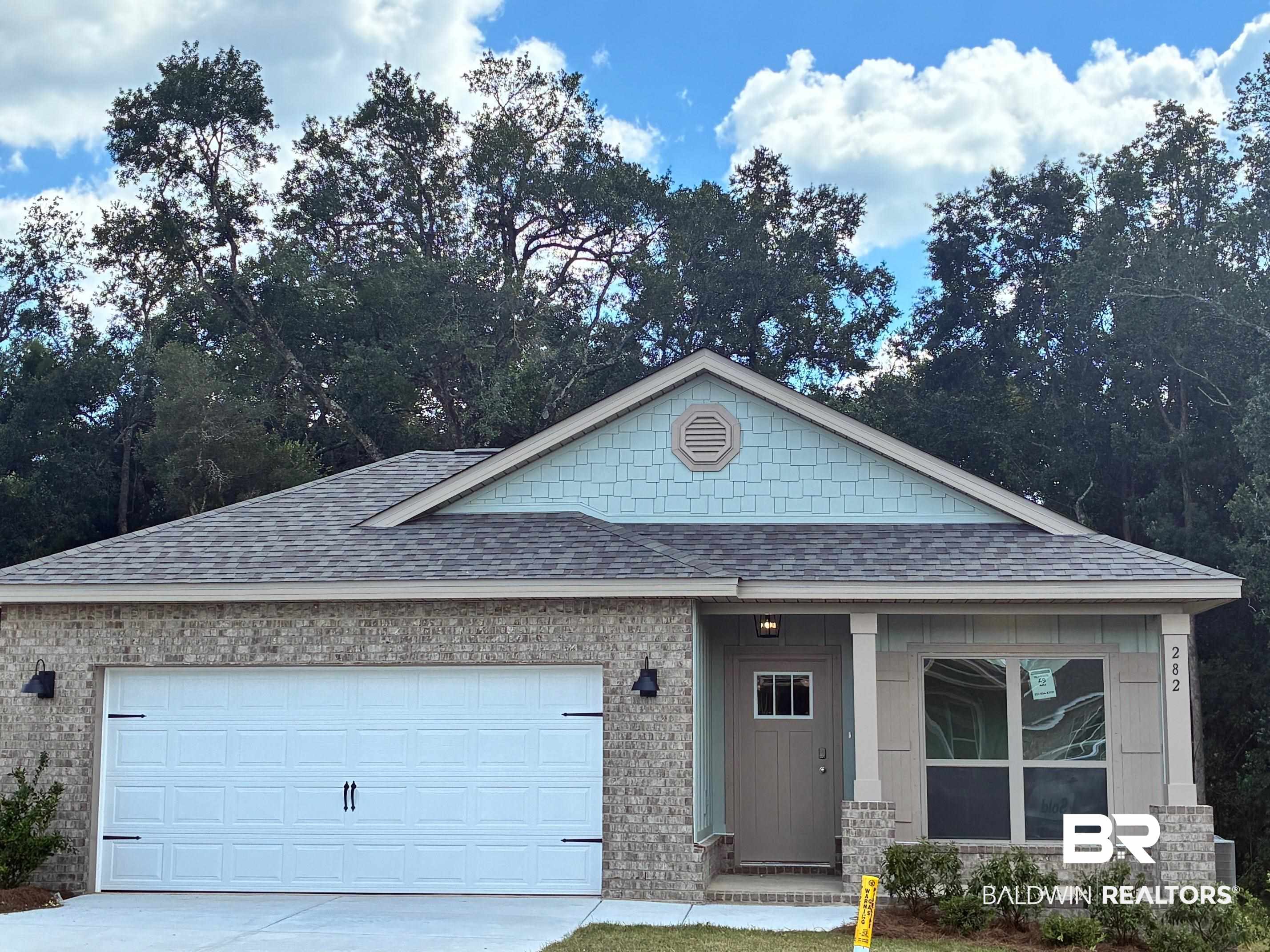 282 Hudson Loop Fairhope, AL 36532 - Photo 1 of 40 Ranch-style house featuring a shingled roof, covered porch, concrete driveway, an attached garage, and brick siding
