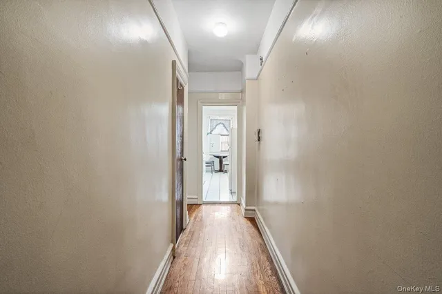 a view of hallway with wooden floor