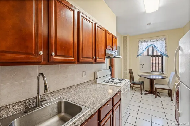 a kitchen with a sink cabinets and outdoor space