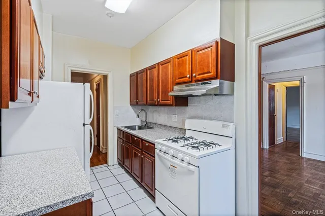 a kitchen with stainless steel appliances granite countertop a refrigerator and a stove