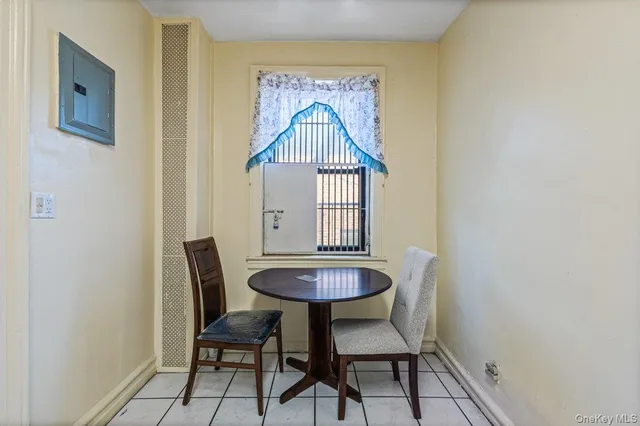 a view of a room with a table and chairs