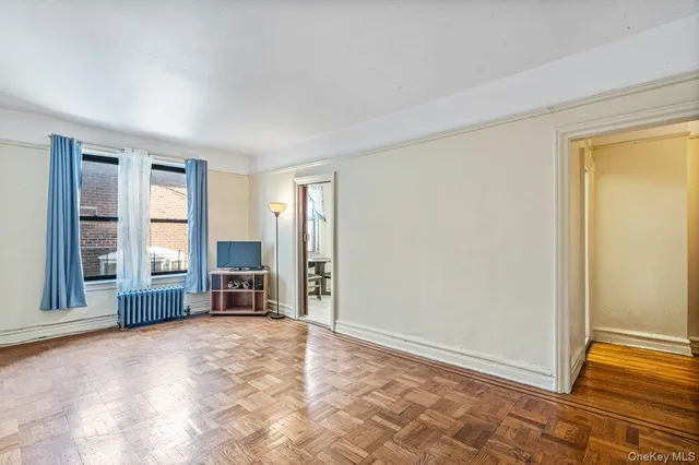 a view of empty room with a fireplace and large windows