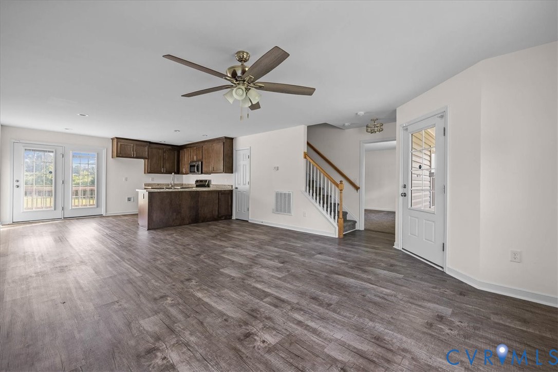 11325 Webb Road Disputanta, VA 23842 - Photo 6 of 32 a view of a livingroom with wooden floor and a kitchen