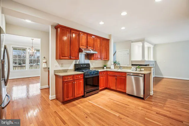 a view of a kitchen with wooden floor and a sink
