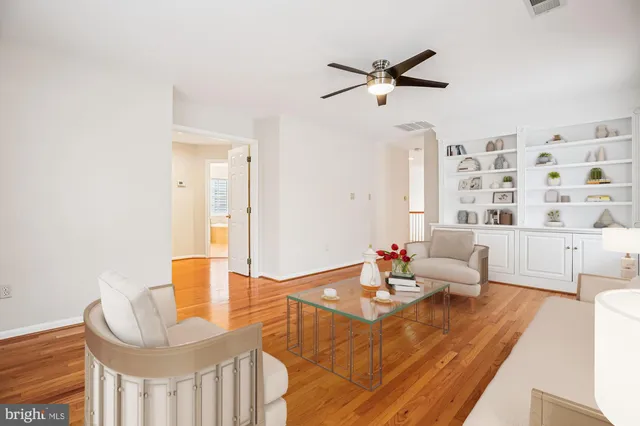 a spacious bedroom with a bed and wooden floor