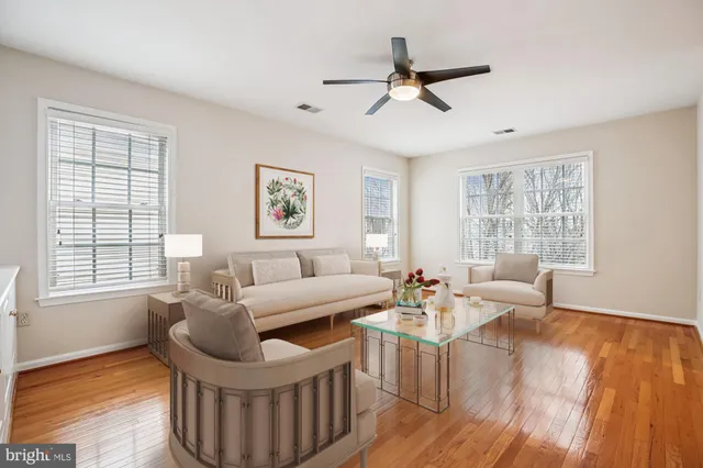 a bedroom with a bed a couch and a flat screen tv