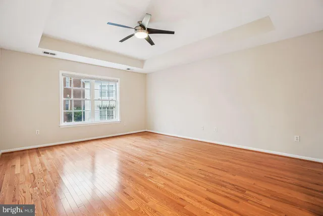 a spacious bathroom with a tub sink and mirror