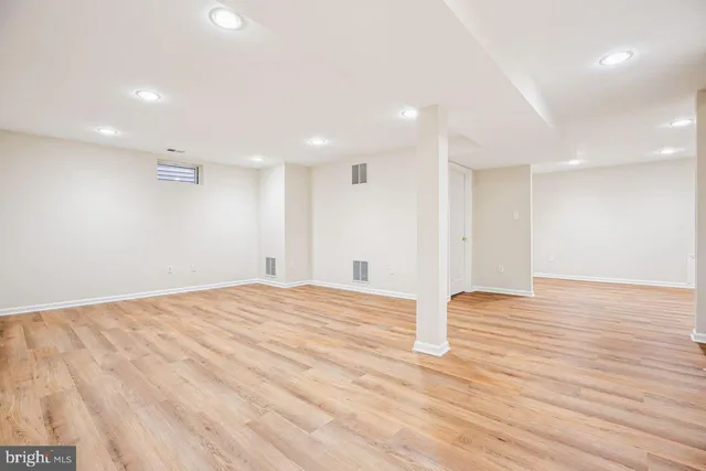 a street sign on a sidewalk next to a road