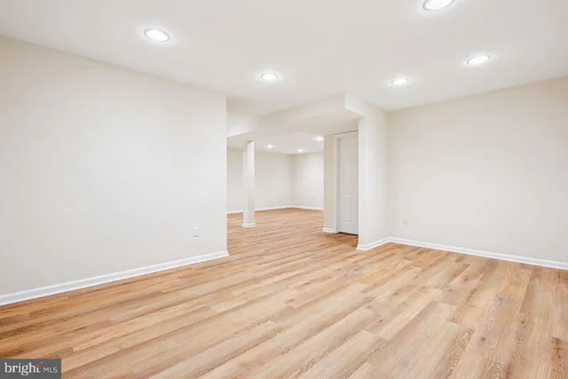 a street sign on a sidewalk next to a building