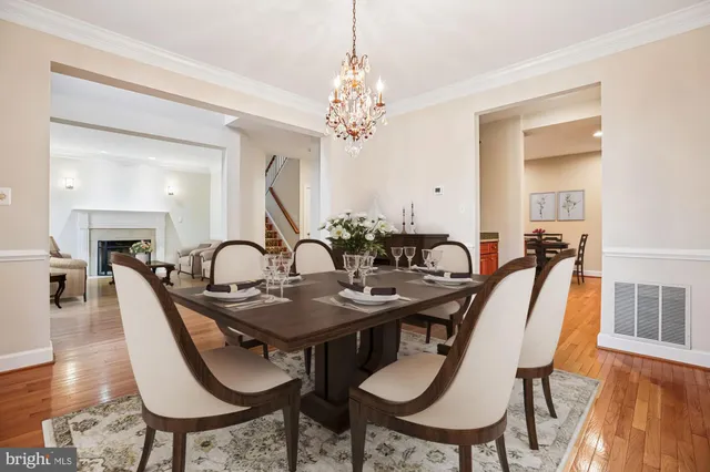 a view of a dining room with furniture wooden floor and chandelier