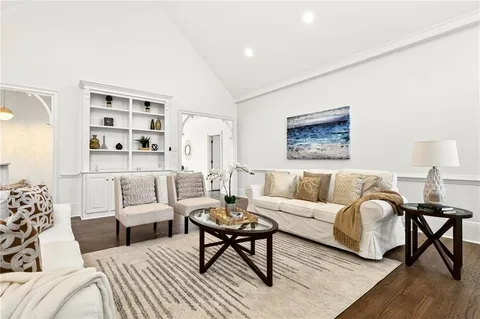 a living room with furniture a rug and a lamp