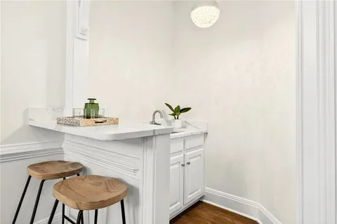 a bathroom with a sink a chair and a mirror