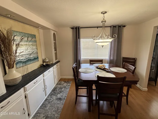 a kitchen with granite countertop a sink stove and refrigerator