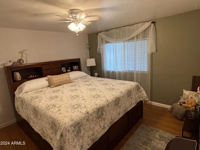 a bed sitting in a bedroom next to a window
