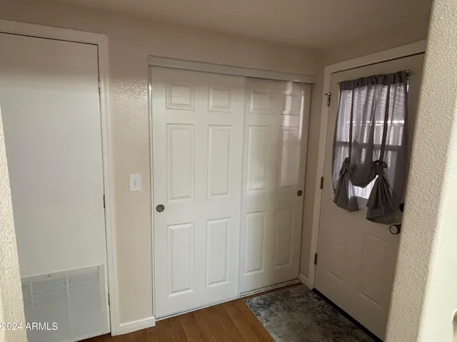 a view of a room with wooden floor