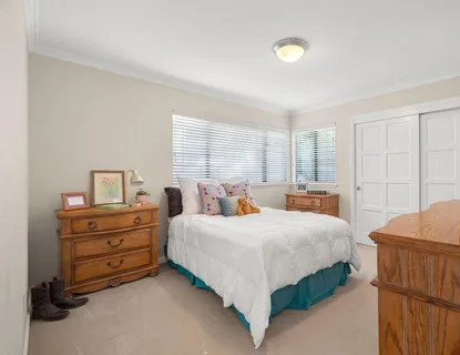 a bedroom with a bed and a dresser