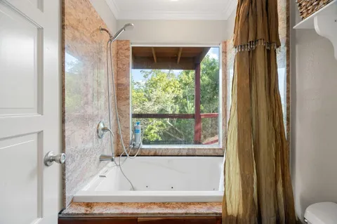 a bathroom with a tub and a shower