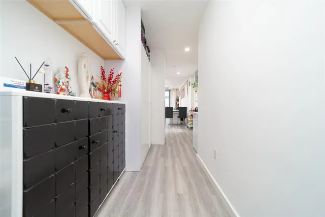 a view of hallway with wooden floor