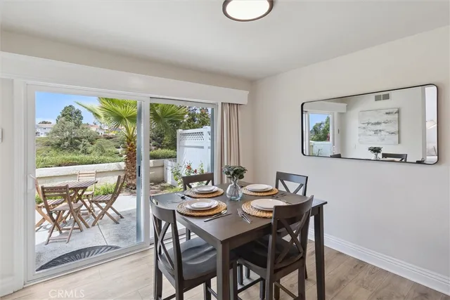 a dining room with furniture and a large window