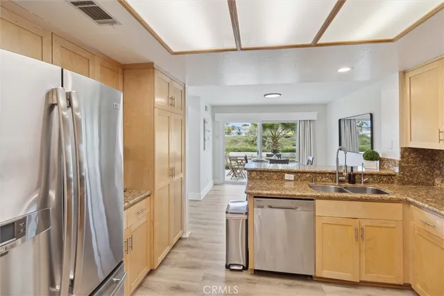 a kitchen with cabinets and stainless steel appliances