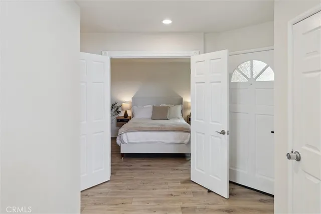 a bedroom with a bed and a mirror