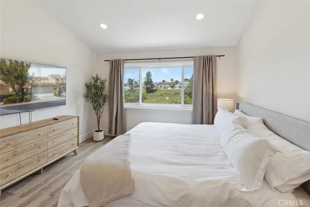 a bedroom with a large bed and a dresser