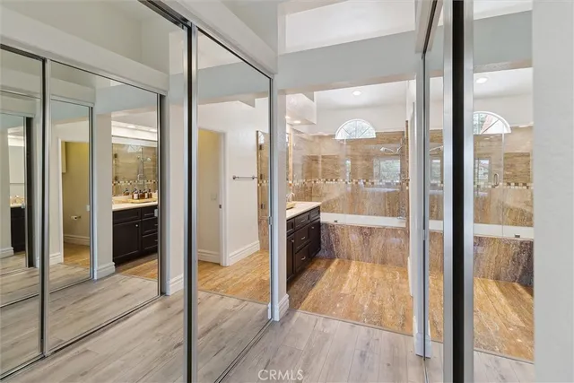 a bathroom with a glass shower door and a mirror
