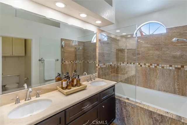 a bathroom with a sink double vanity and a shower