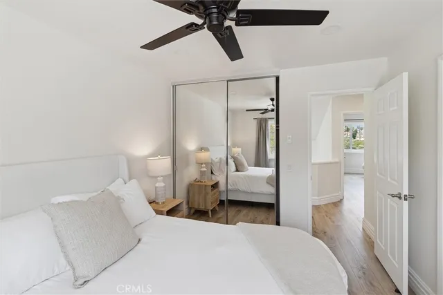 a bedroom with a bed and a mirror