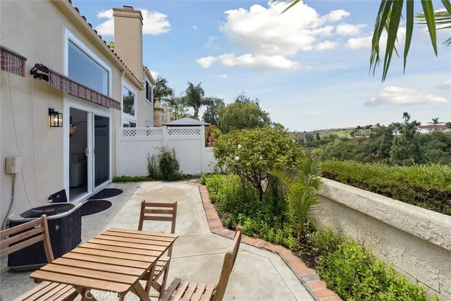 a view of a patio with table and chairs and potted plants