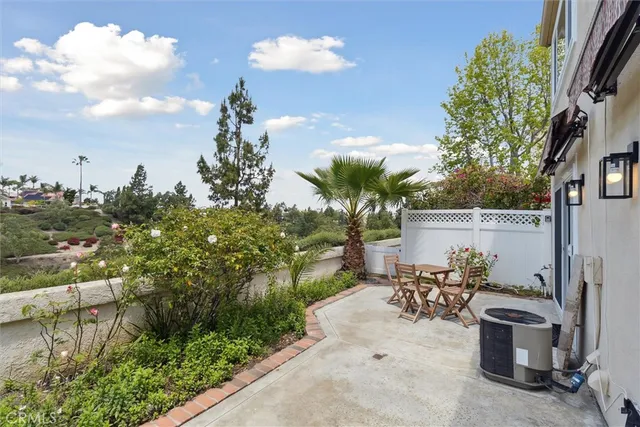 a view of a patio with table and chairs and potted plants
