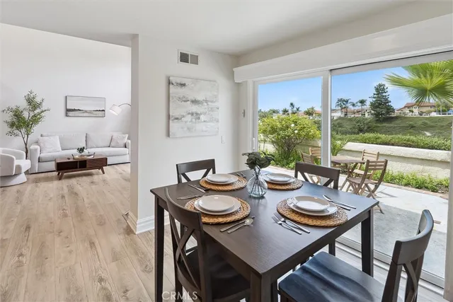 a view of a dining room and livingroom with furniture window and garden view