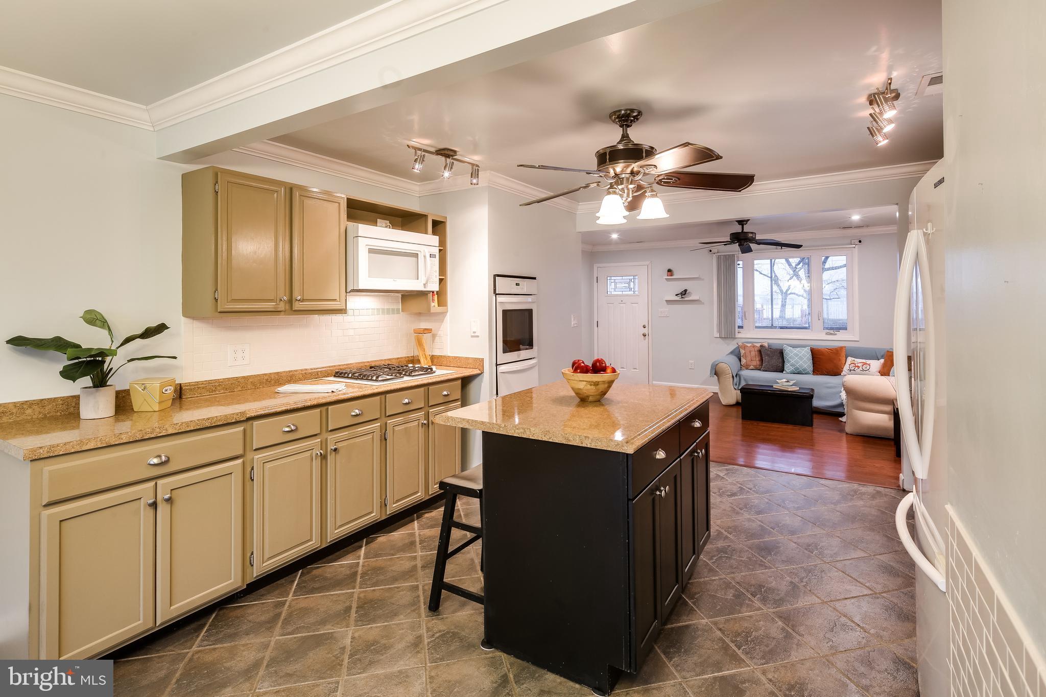 8255 Bullneck Road Baltimore, MD 21222 - Photo 12 of 29 Tiled kitchen floor with wooden cabinetry.