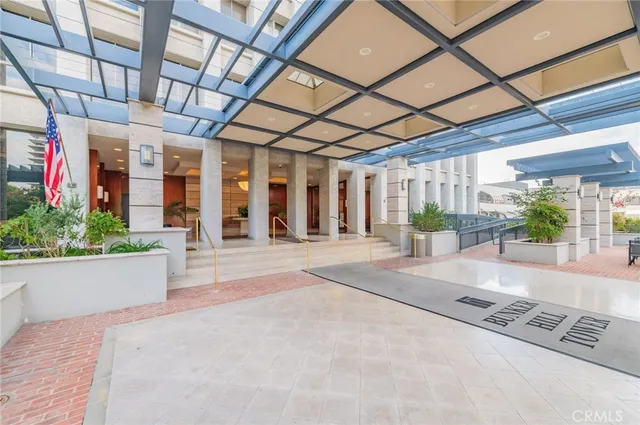 a lobby with furniture and potted plants