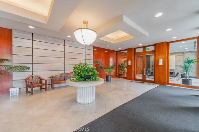 a lobby with furniture and potted plants