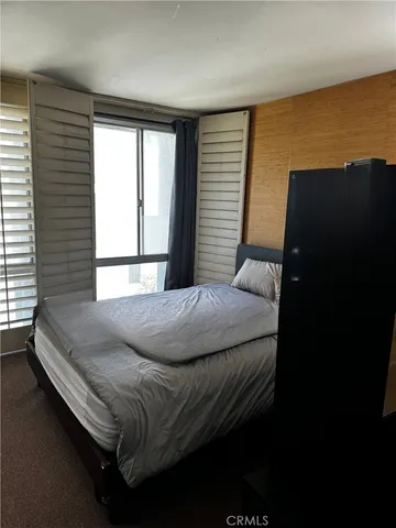 a bedroom with a bed and a window